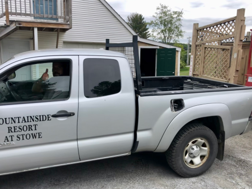 The property manager giving a thumbs up from the Mountainside Resort Truck, which is loaded with several buckets of food scraps.